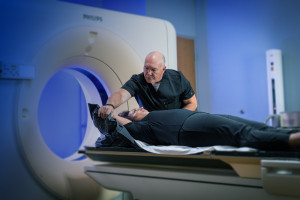 SecureVac bag being shaped around patient for cancer treatment by Radiation Therapist.
