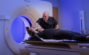 SecureVac bag being shaped around patient for cancer treatment by Radiation Therapist.