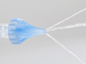OtoClear tip spraying water for ear irrigation.