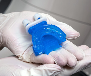 TruGuard tongue and jaw protector held by clinican